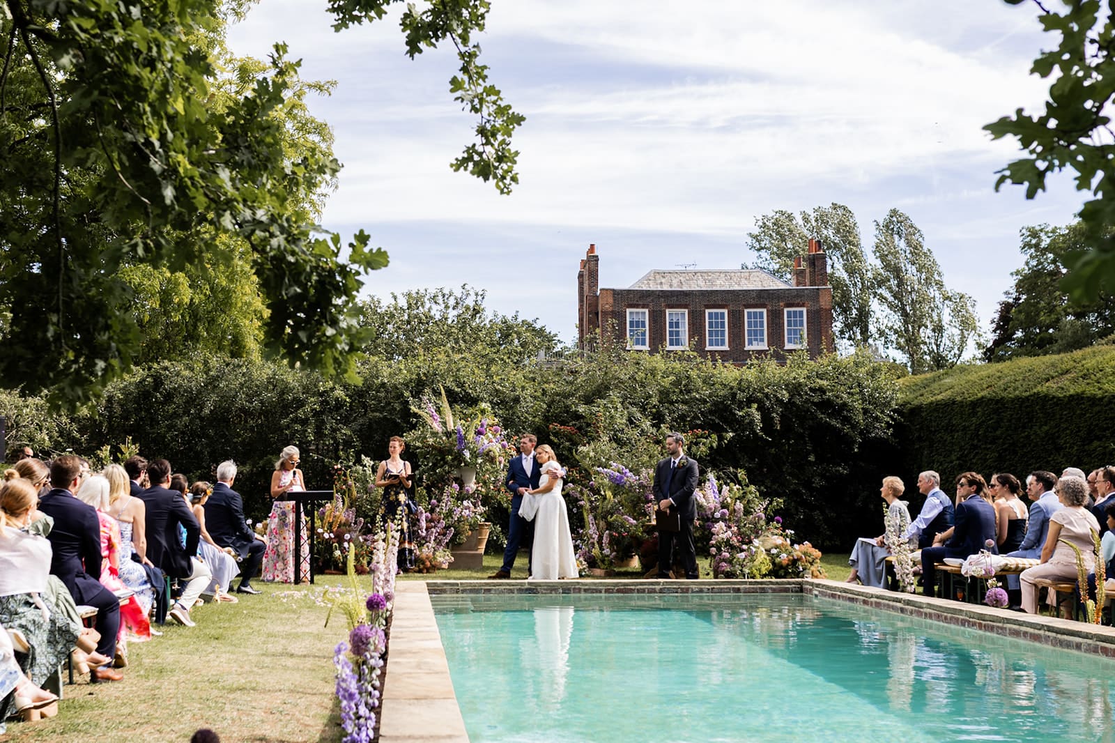 Bride and Groom at Petersham Nursery's wedding ceremony by the swimming pool